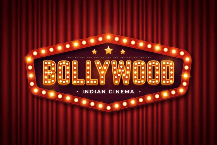 Illuminated Bollywood marquee against red theater curtains