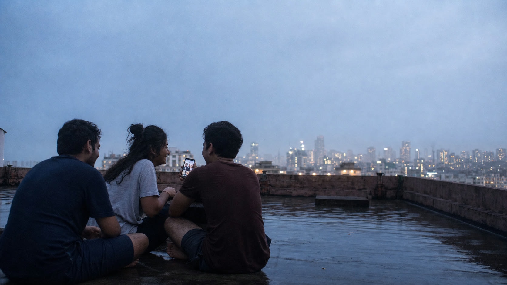 Three friends on a city rooftop at blue hour, sharing a quiet moment together